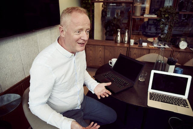 a financial  sitting at a table with a laptop