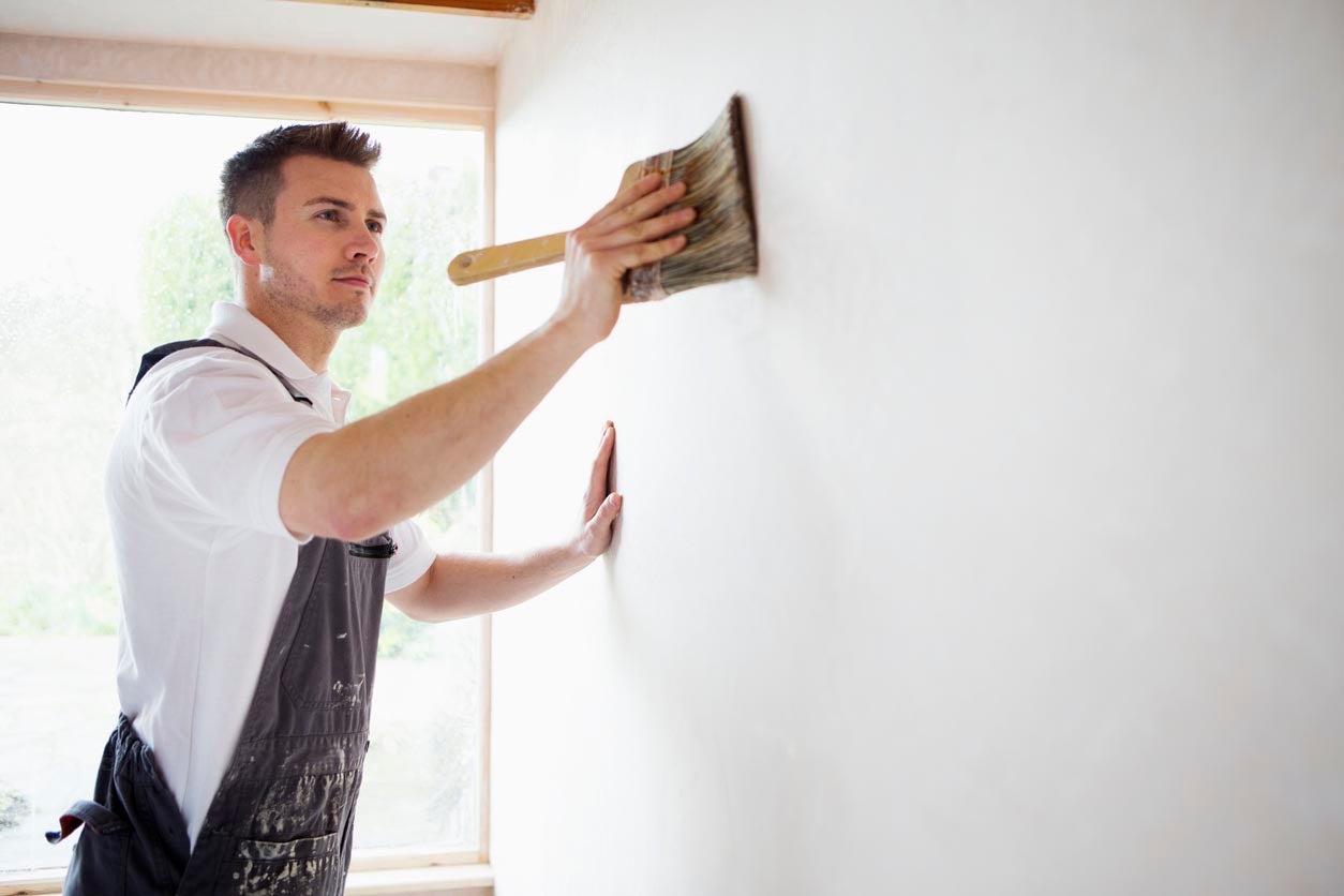 a person painting a wall