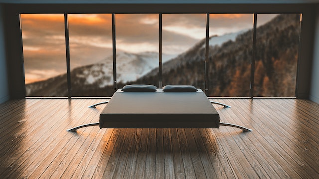 a bed in a room with a view of mountains