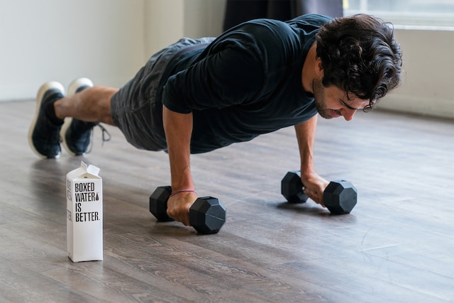 a person doing push ups with weights on the floor