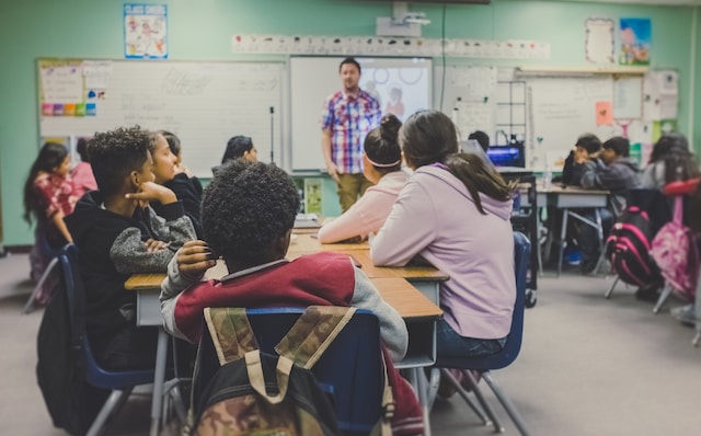 a person standing in front of a classroom