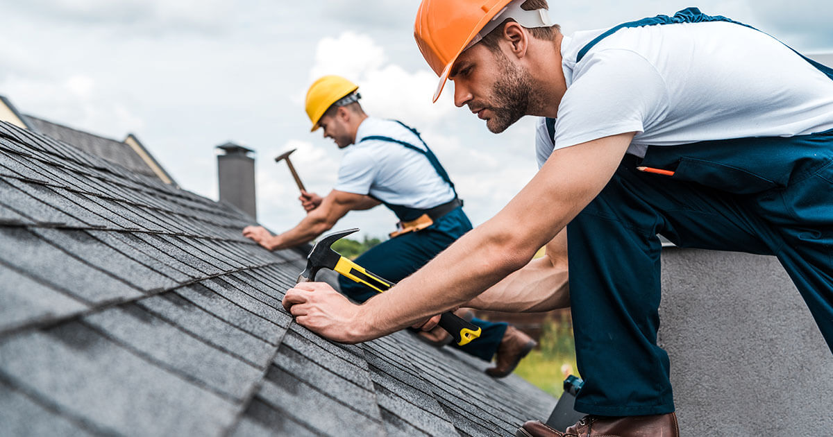 a group of men working on a roof