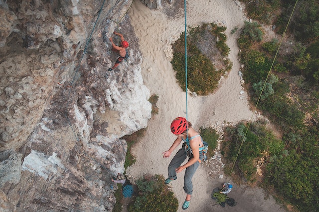 a person wearing a helmet from a rope