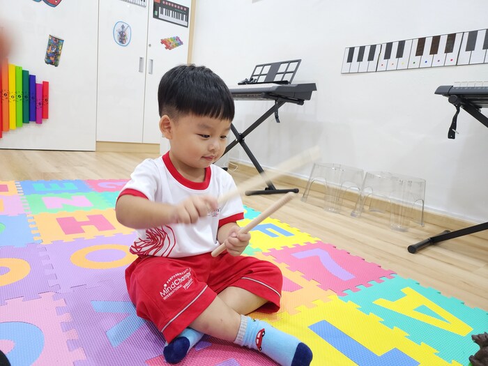 Preschool child joyfully exploring rhythmic dance and creative expression with props