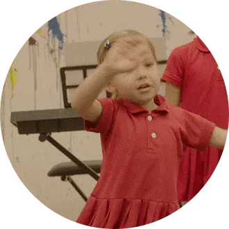 Preschool child confidently expressing and acting during an interactive performing arts session