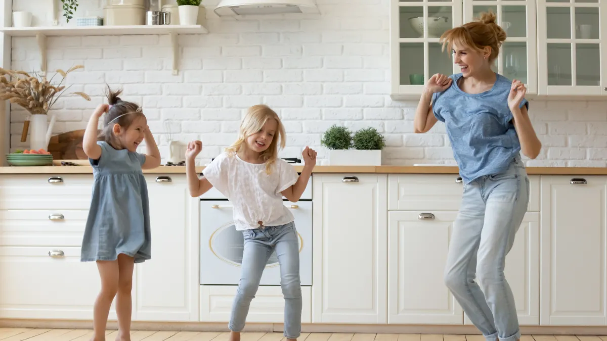 Mum dancing with her two girls