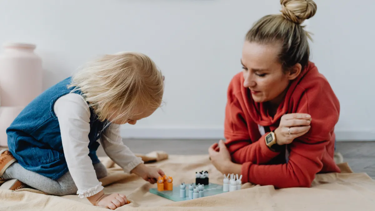 Playing a game with their daughter.