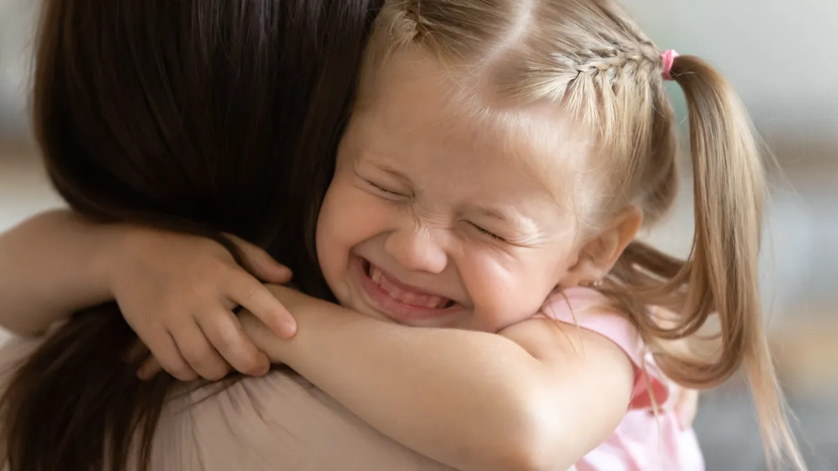 Give mum a big squeeze: young girl