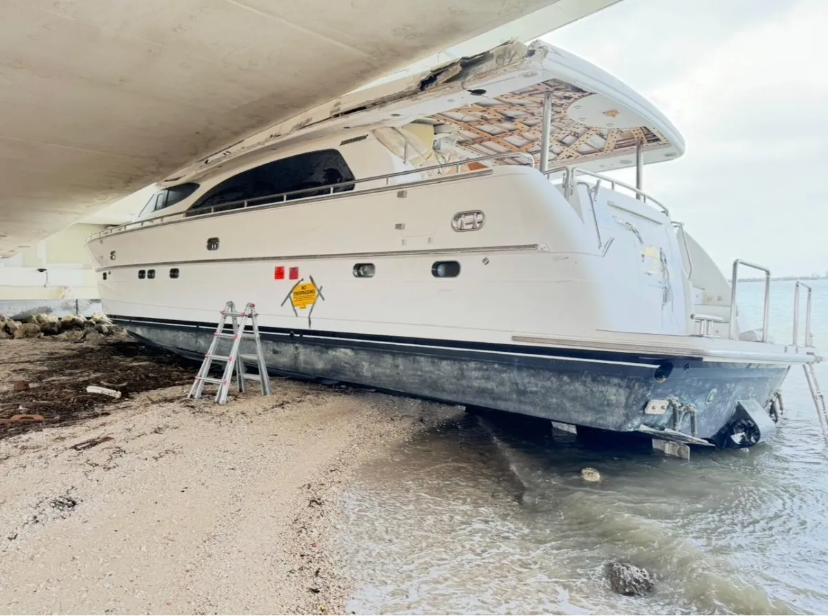 a white boat floating on top of a body of water