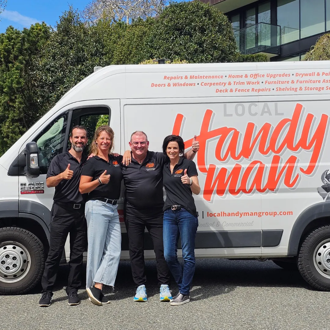 Calgary Handyman franchise team smiling in front of Local Handyman Group signage and service van image.