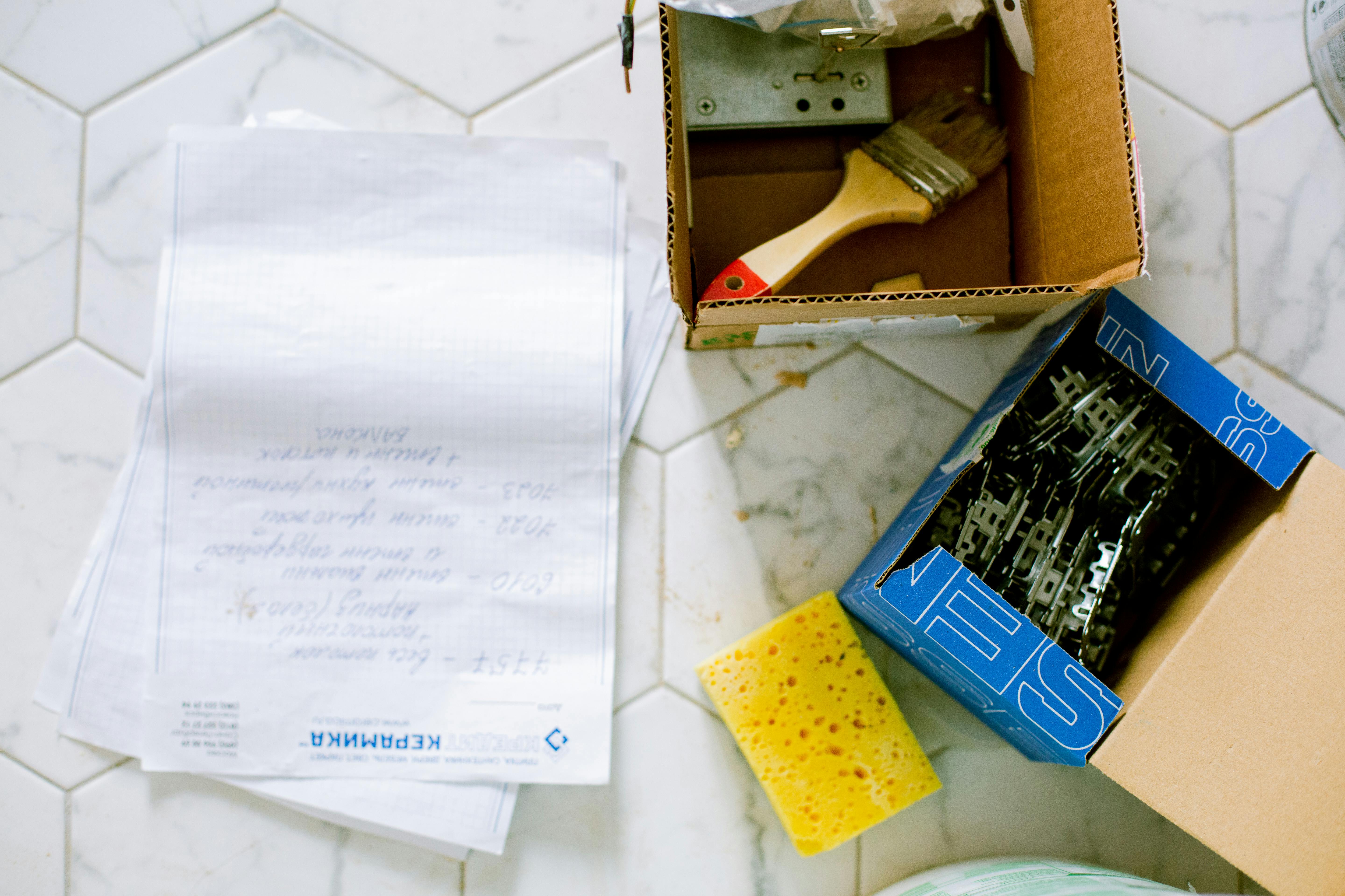 Photo of cleaning supplies and hardware laid out on a work surface, showing the prep materials used before clearing Memphis gutters overloaded by storm debris and fine loess-soil runoff. Represents the detailed setup Local Handyman Midsouth uses to keep downspouts flowing.