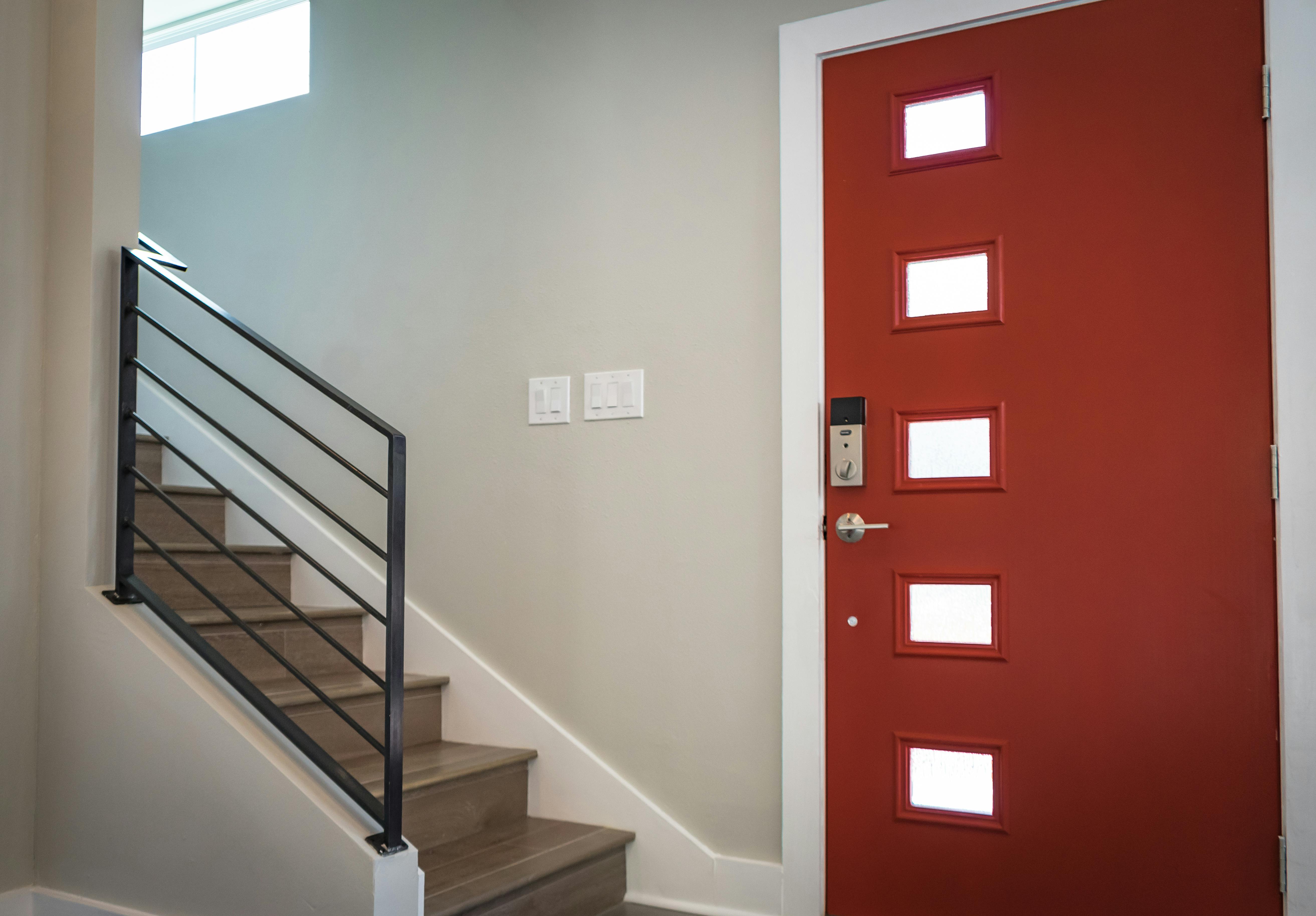 Interior Memphis home with stairway and modern door, showing how framing movement and humidity can affect door fit and smooth operation.