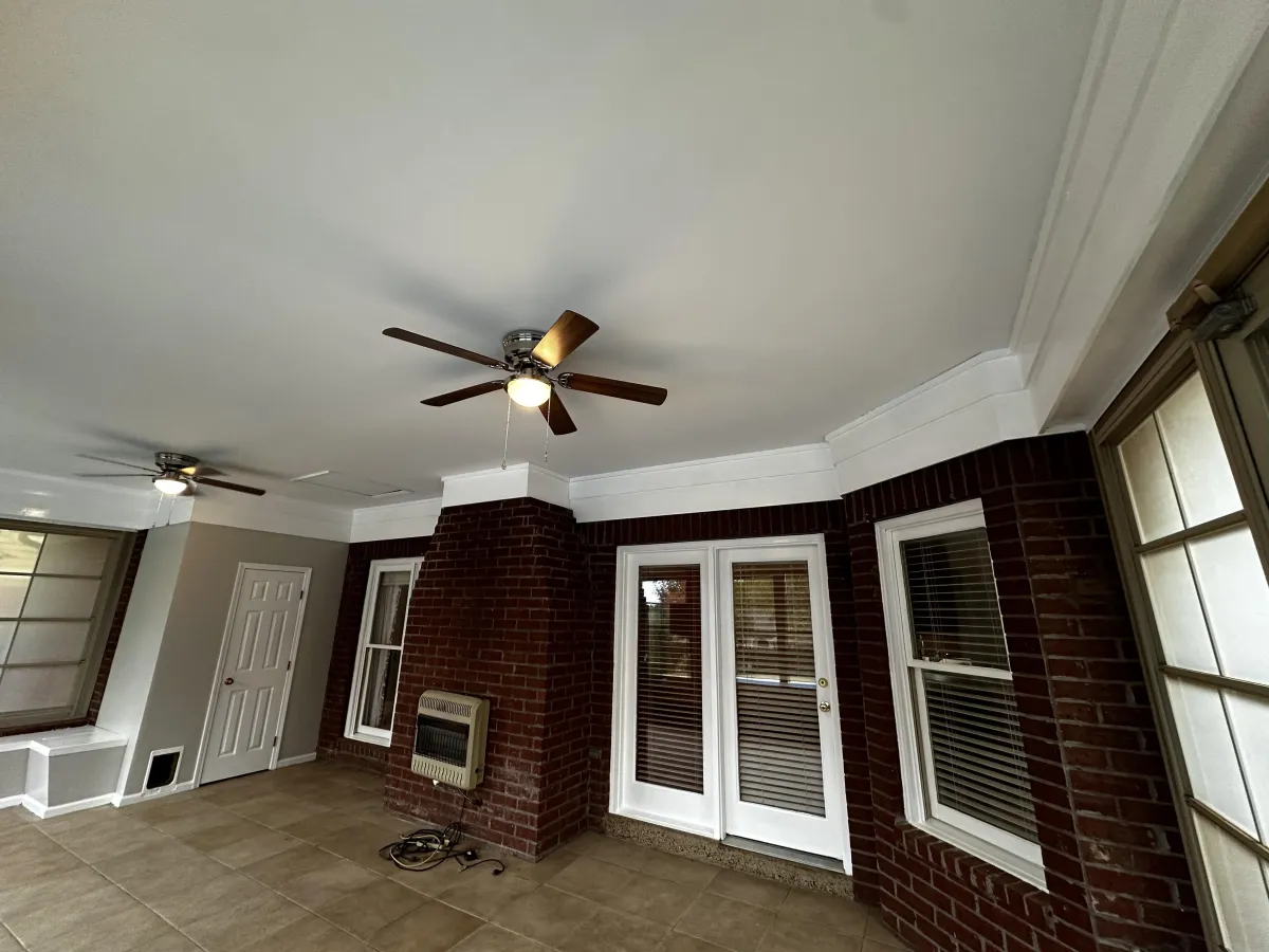 Brick Memphis home entry with exterior doors and ceiling fans, illustrating common door sticking problems caused by humidity, foundation movement, and seasonal expansion.