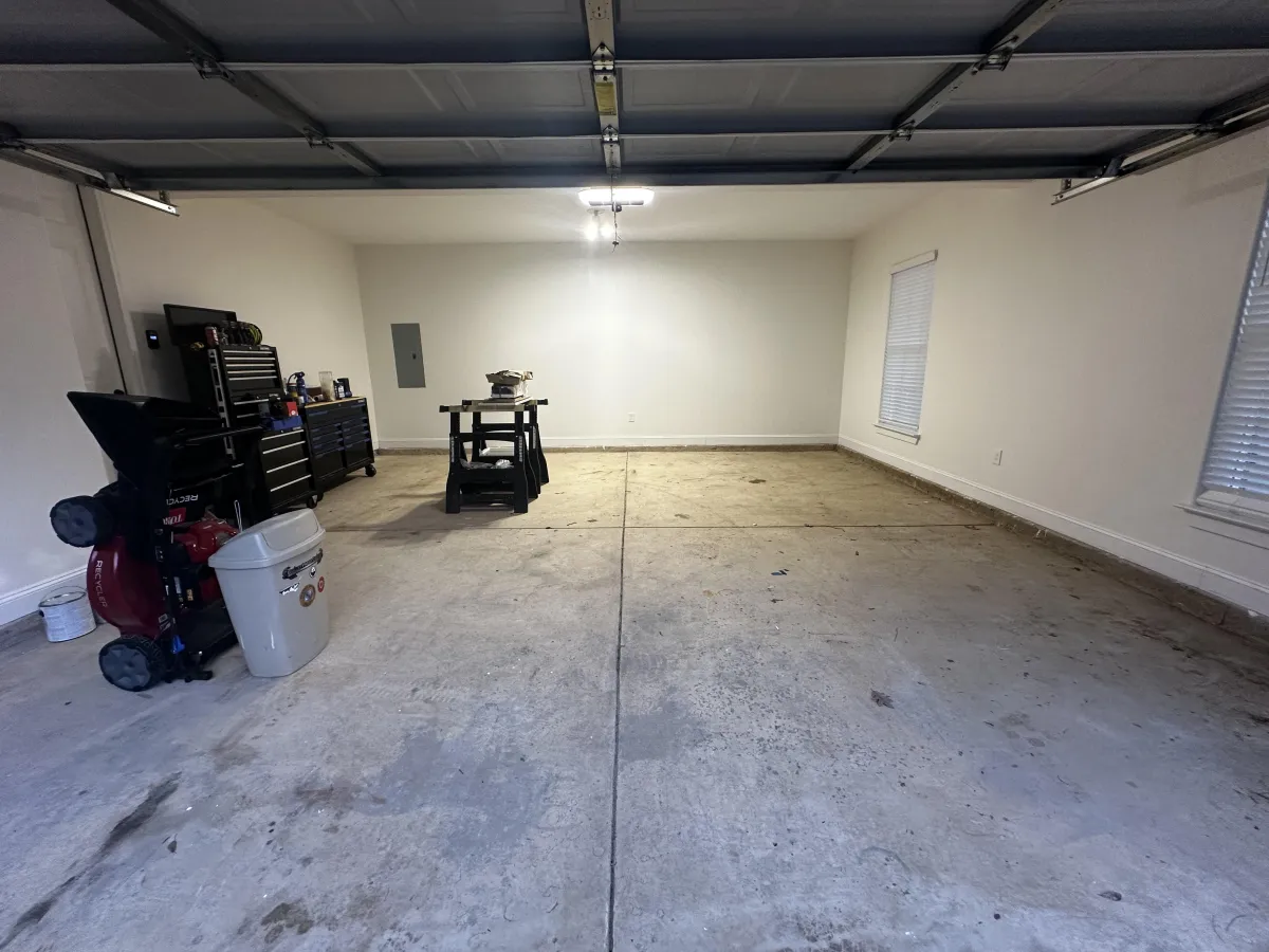 Wide view of a Memphis garage with concrete slab and finished walls, commonly inspected when diagnosing squeaky floors and floor movement above.