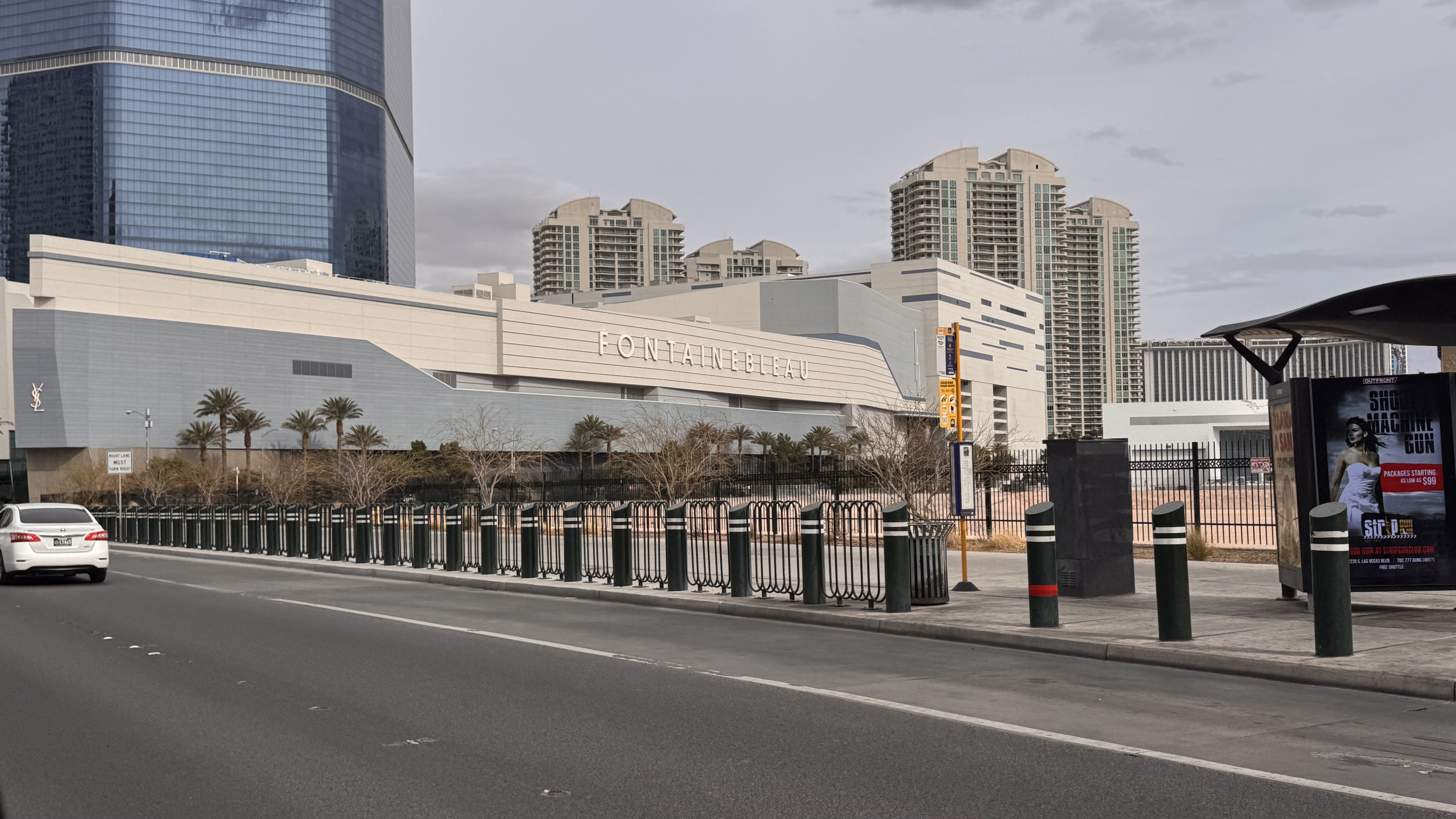 The Fontainebleau Hotel and Casino in Las Vegas, Nevada, with modern architecture, palm trees, and urban street scene visible.