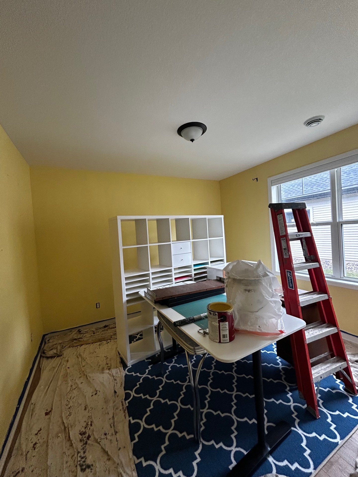 Modern office space repainted in bright, clean white with accent wall