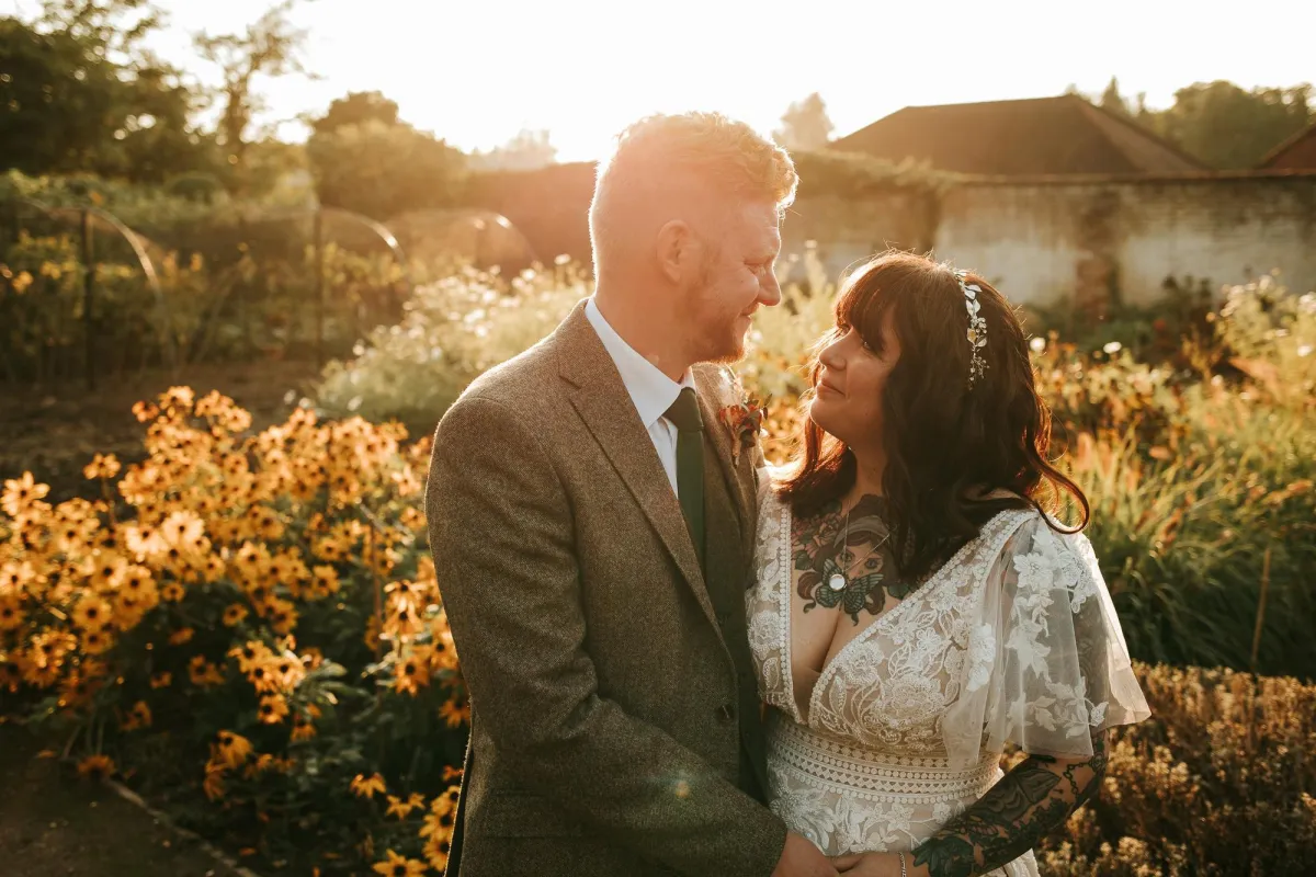 Relaxed wedding photographer taking photo of wedding couple