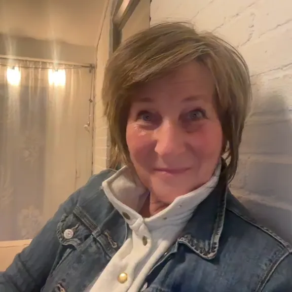 short-haired black cat besides brown wooden table