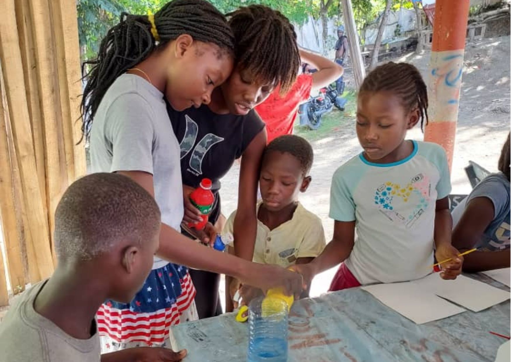 Youth participants engage in a hands-on learning activity during a Boujonnen Foundation program, demonstrating how donor support creates opportunities for education, leadership, and personal growth.