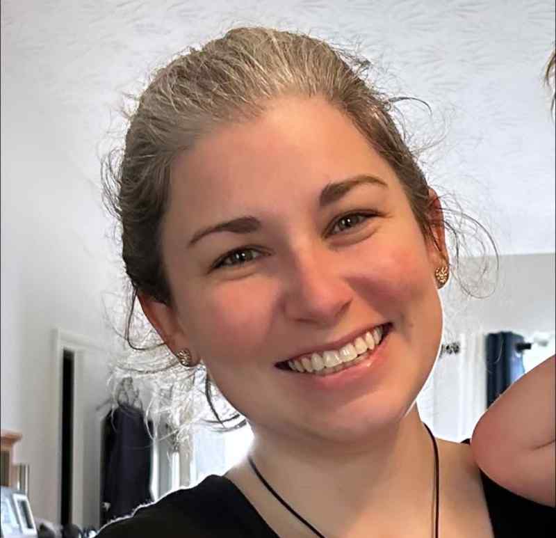 Madeline Cox smiling in a casual headshot.