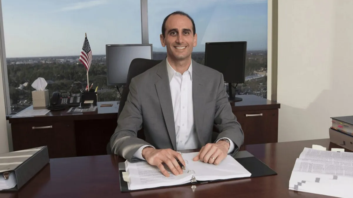 Ex-IRS trained agent sitting at a desk in an office with paperwork, ready to provide personalized back tax strategy advice