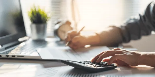 Hands typing IRS debt relief steps to remove penalties and interest from back taxes