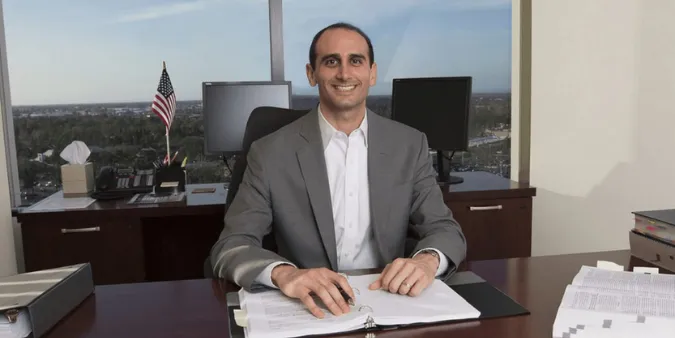 Ex-IRS trained agent sitting at a desk in an office with paperwork, ready to provide personalized back tax strategy advice