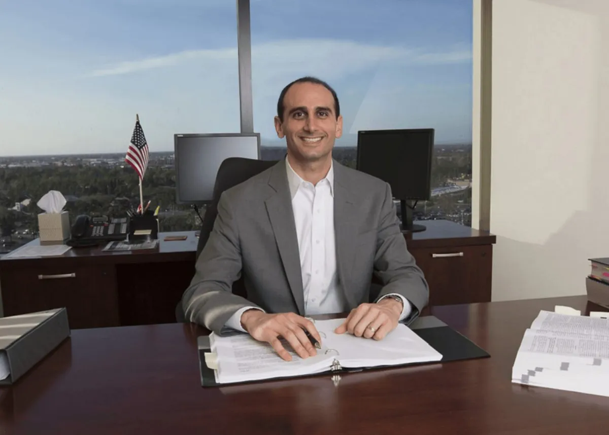 Ex-IRS trained agent sitting at a desk in an office with paperwork, ready to provide personalized back tax strategy advice