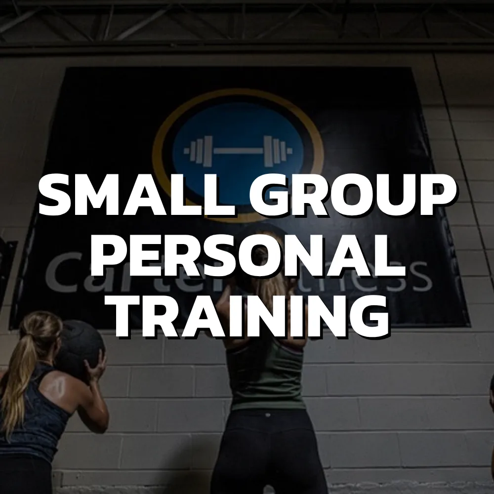 Small group personal training in Cincinnati with adults lifting weights and receiving coaching in strength class