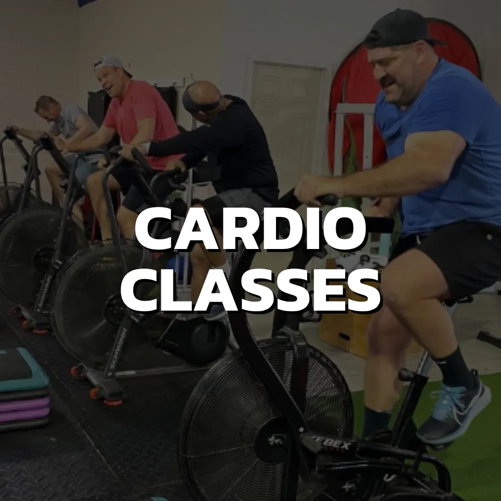 High-energy cardio class in Cincinnati with adults performing group fitness workout for fat loss and conditioning
