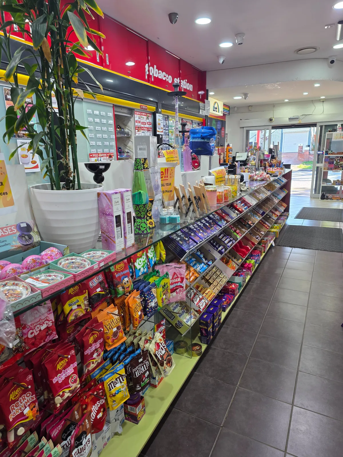 Customer buying daily groceries and checking a Lotto ticket at the counter