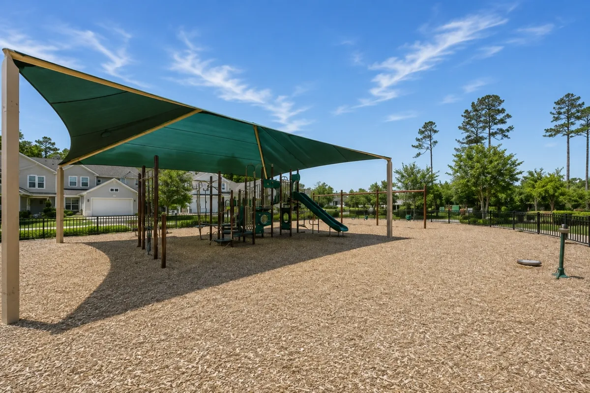 Shaded neighborhood playground at The Colony park in Twenty Mile at Nocatee