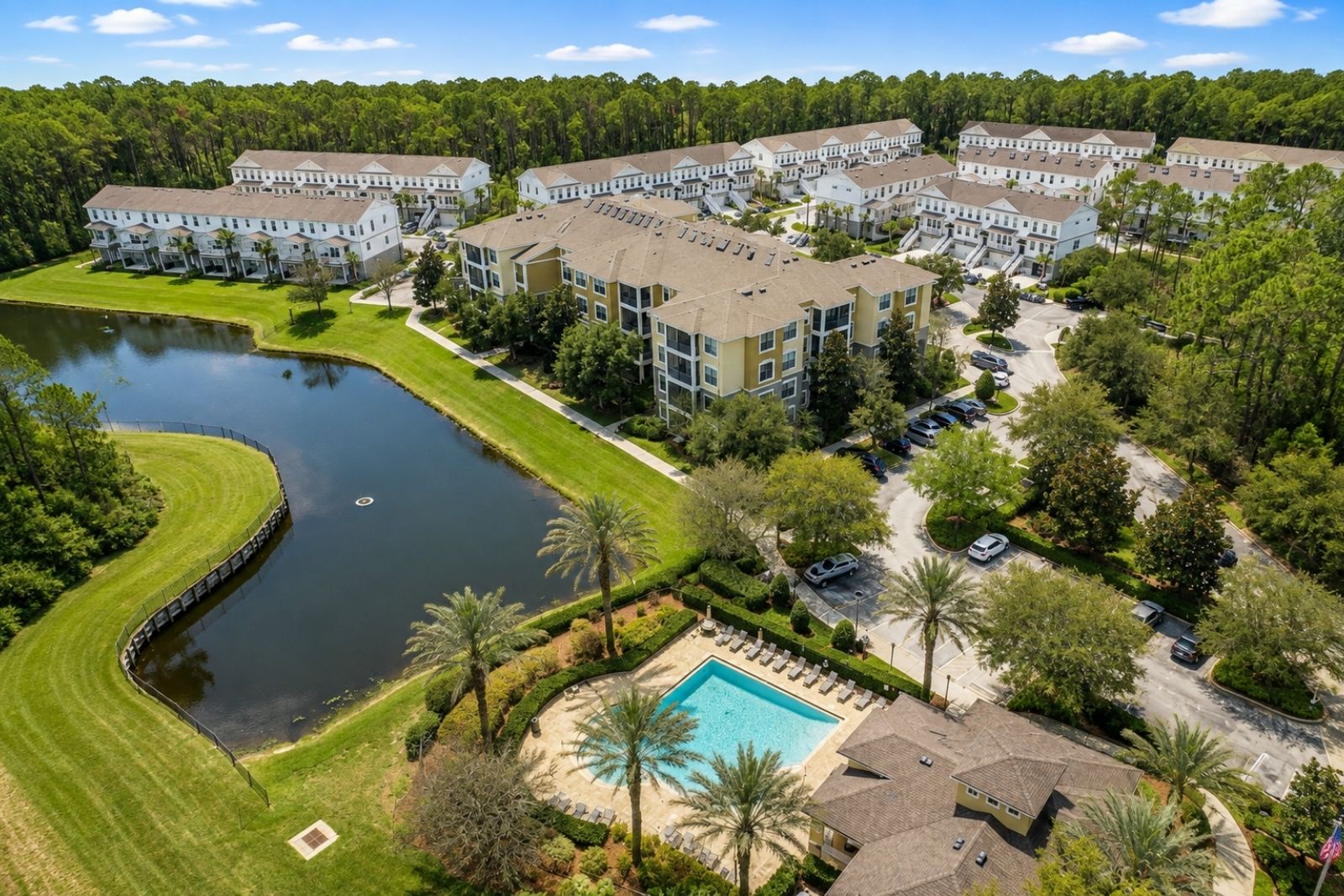 Aerial view of Tidewater at Nocatee showing condominium buildings, pool and lake