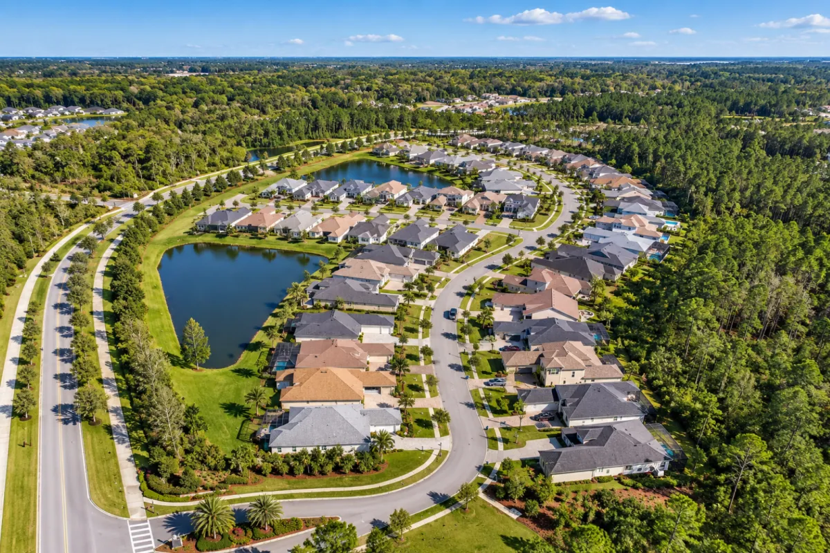 Aerial view of The Junction at Twenty Mile showing homes, water and preserved woodland in Nocatee