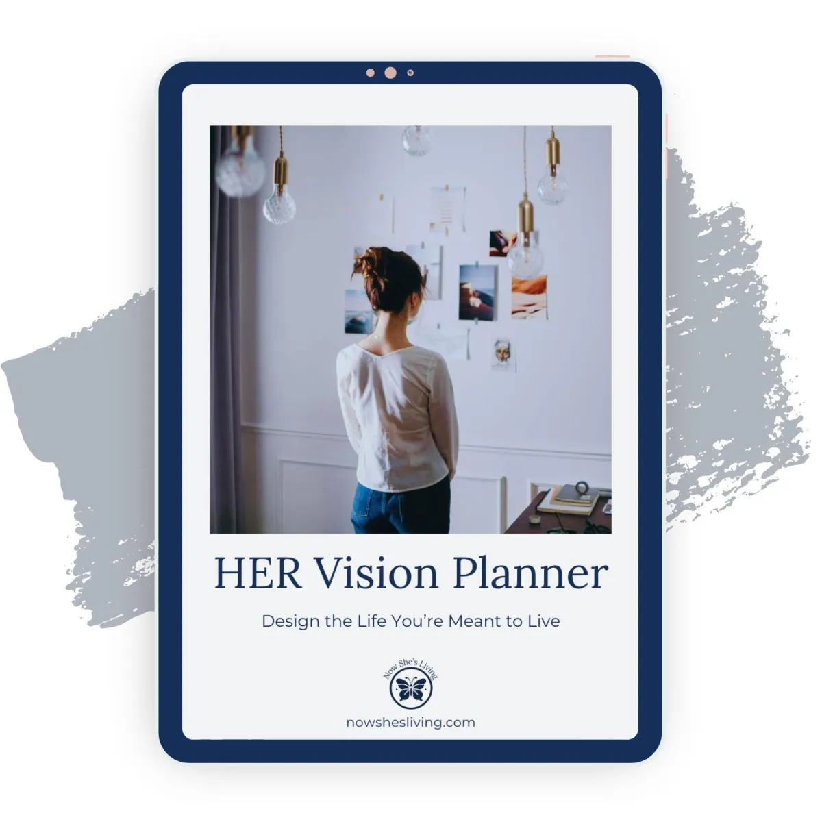 A woman with her hair tied up, standing in front of a wall covered with photos and inspirations, surrounded by stylish hanging lights. The text reads 'HER Vision Planner - Design the Life You're Meant to Live