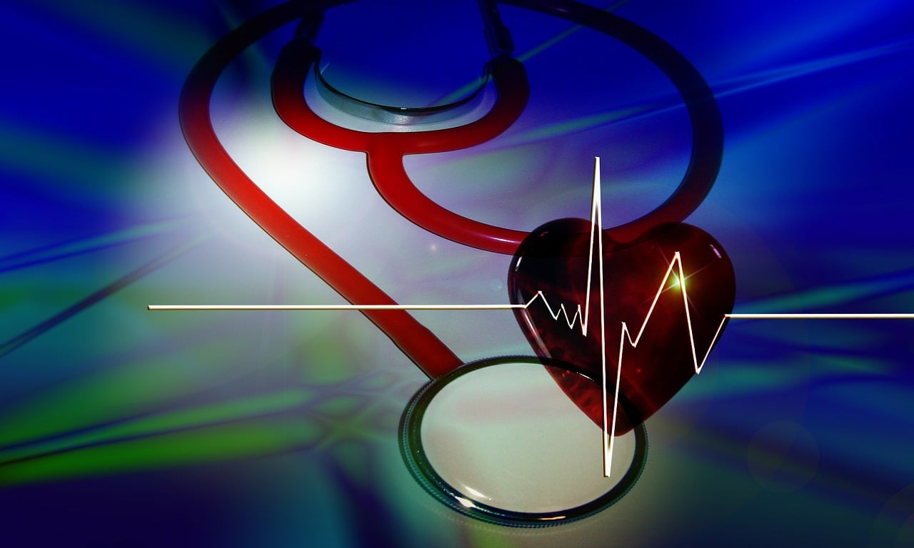 stethoscope with perspex heart on a blue and green back ground