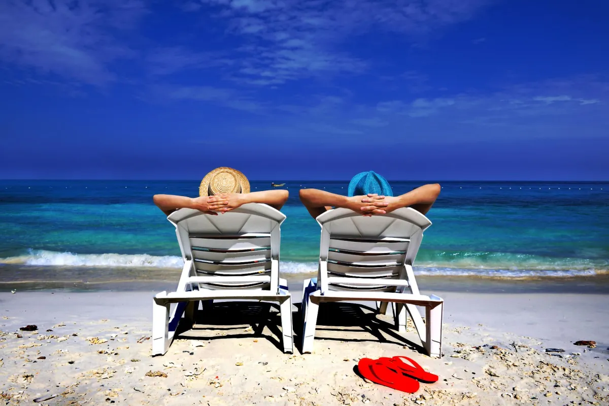 Couple enjoying time off by the ocean, illustrating the freedom our automation tools provide