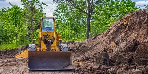 Bulldozer at a construction site moving soil for earthworks and land preparation