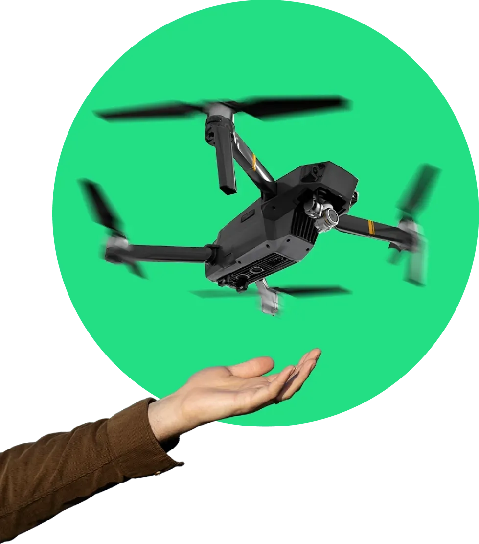 Hand launching a professional drone against a green background for aerial surveying and mapping