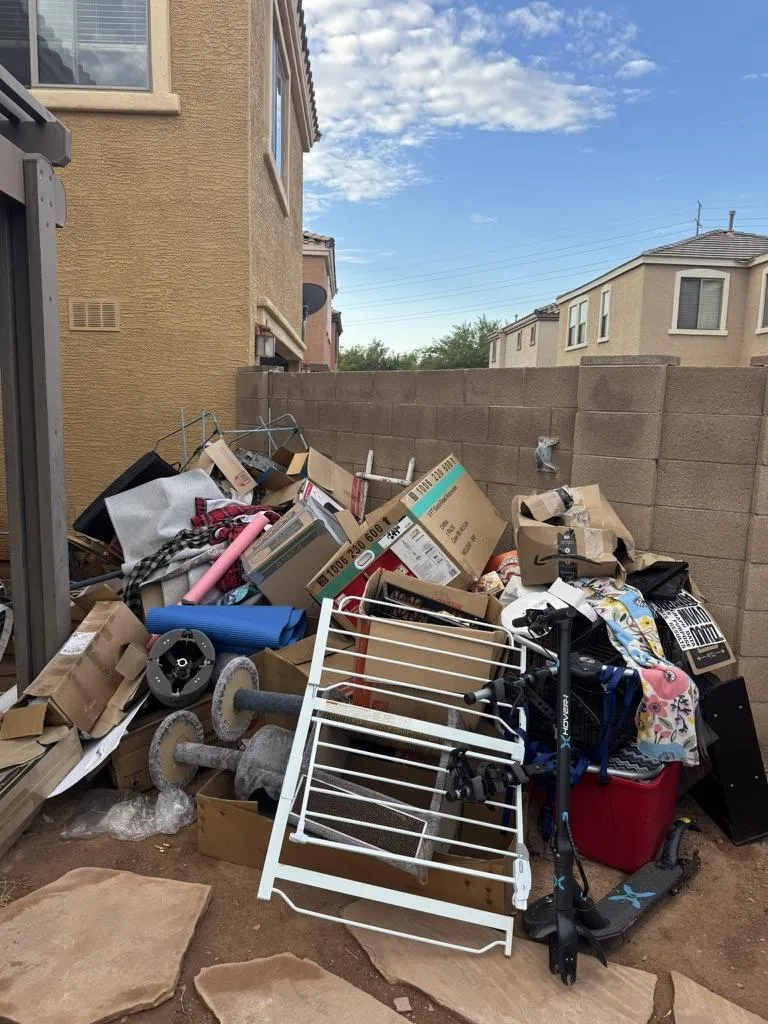 a pile of trash sitting next to a metal fence