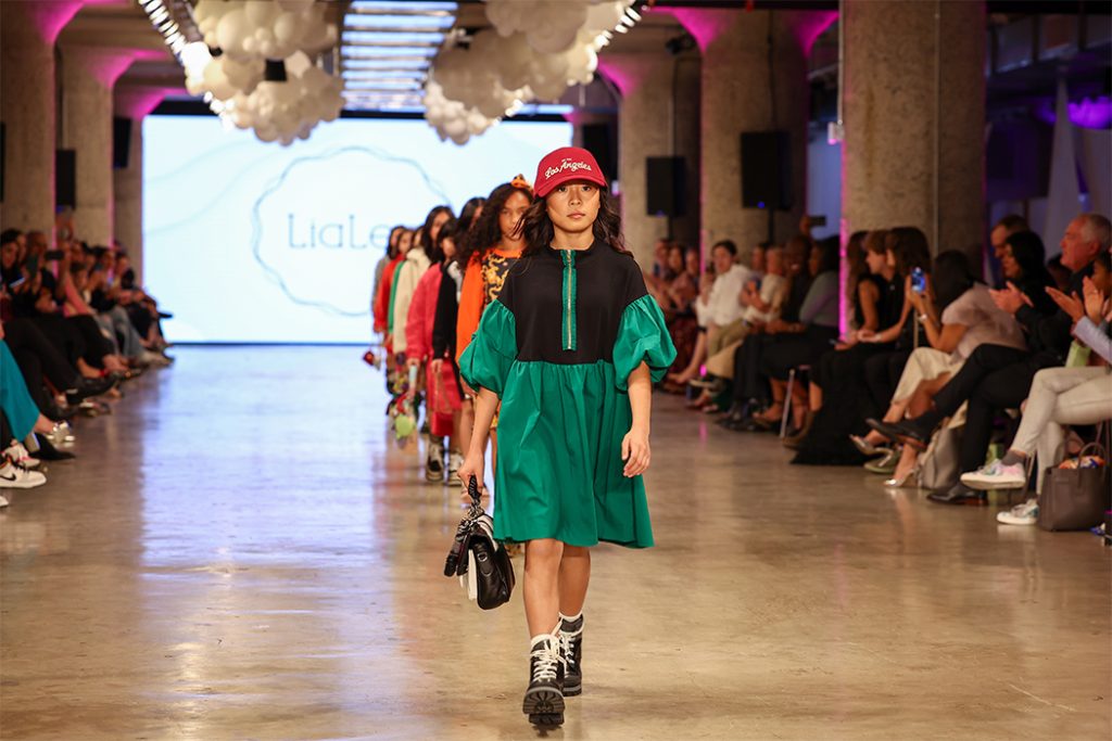 Teens performing a synchronized K-Pop dance routine in a high-tech studio