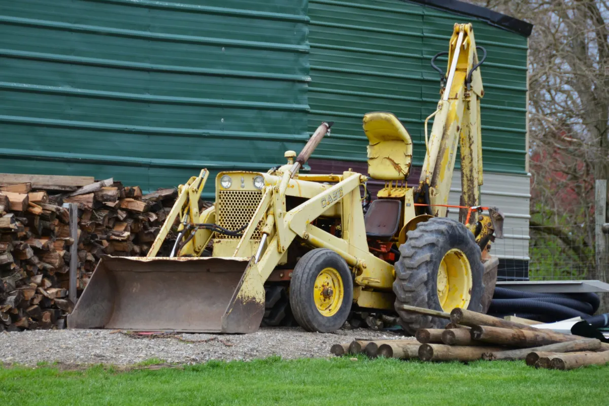 Loader moving branches and logs, offering tree chipping and hauling services in Roanoke Virginia