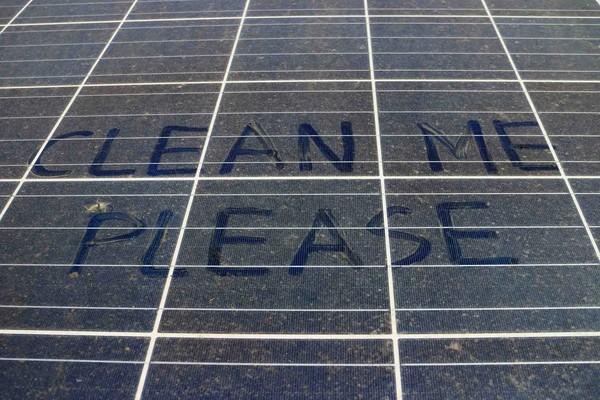 Solar panels on a home roof with visible dirt buildup reducing efficiency