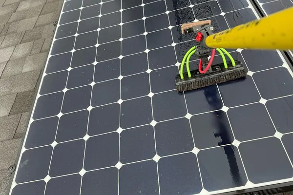 Homeowner considering DIY solar panel cleaning on a rooftop in Plumas Lake, CA