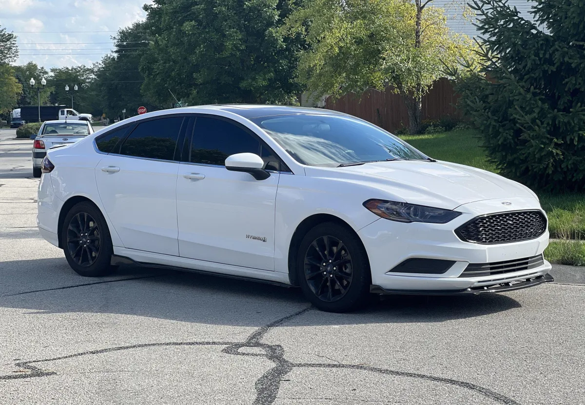 white Ford Sedan on the street