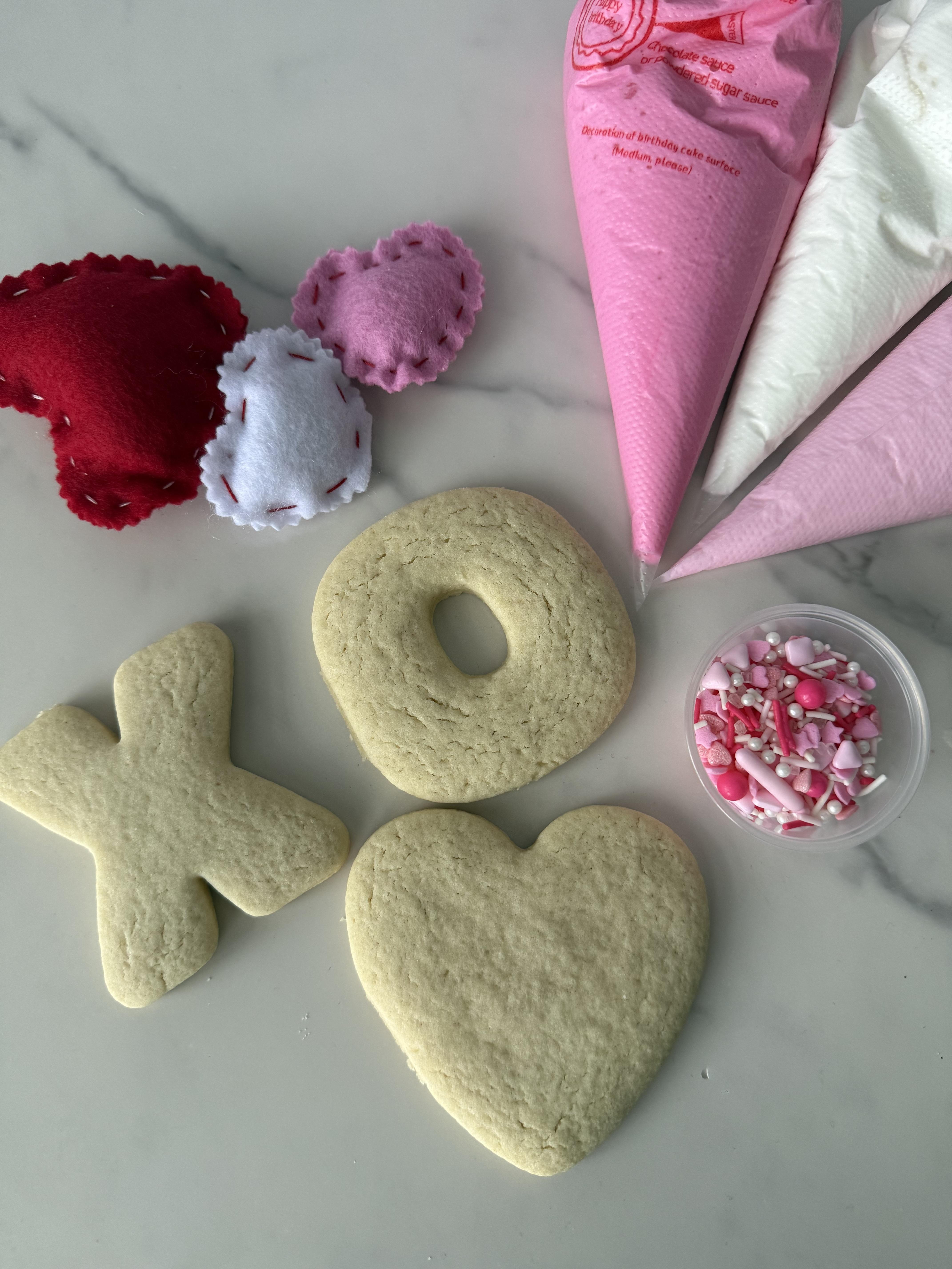 blank cookies with icing and sprinkles