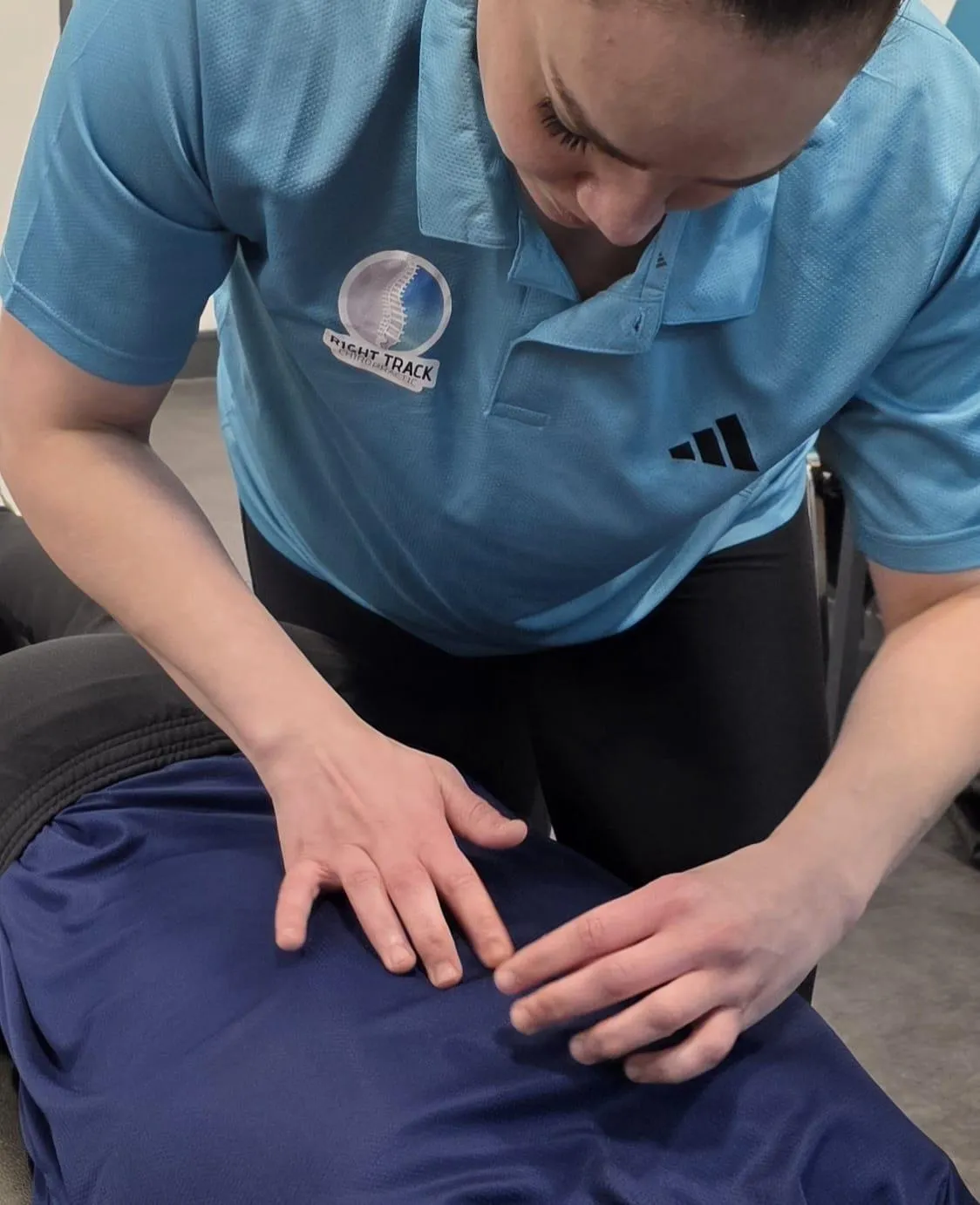 Chiropractor palpating a patient to perform an adjustment