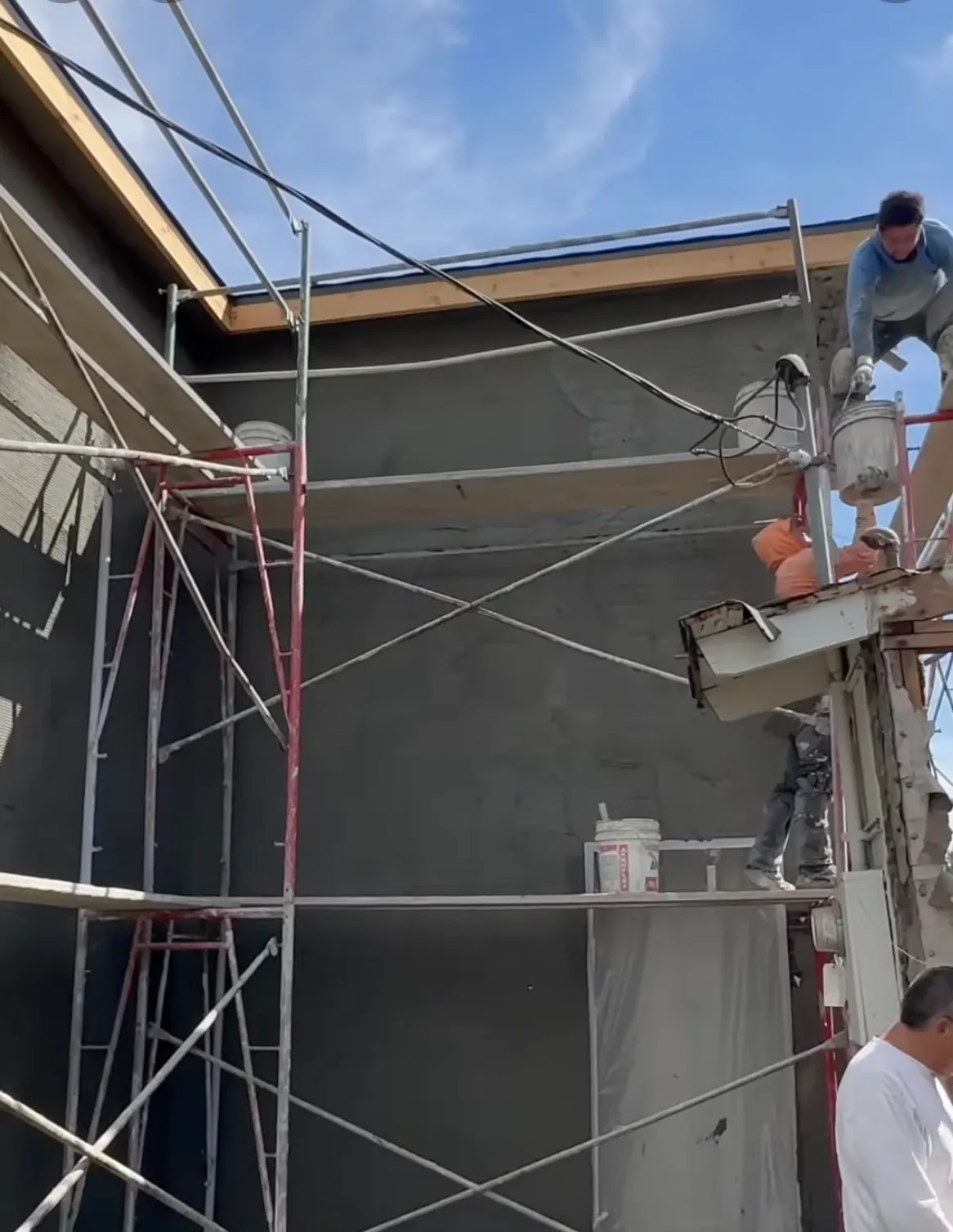 two men working on a commercial stucco constructtion project
