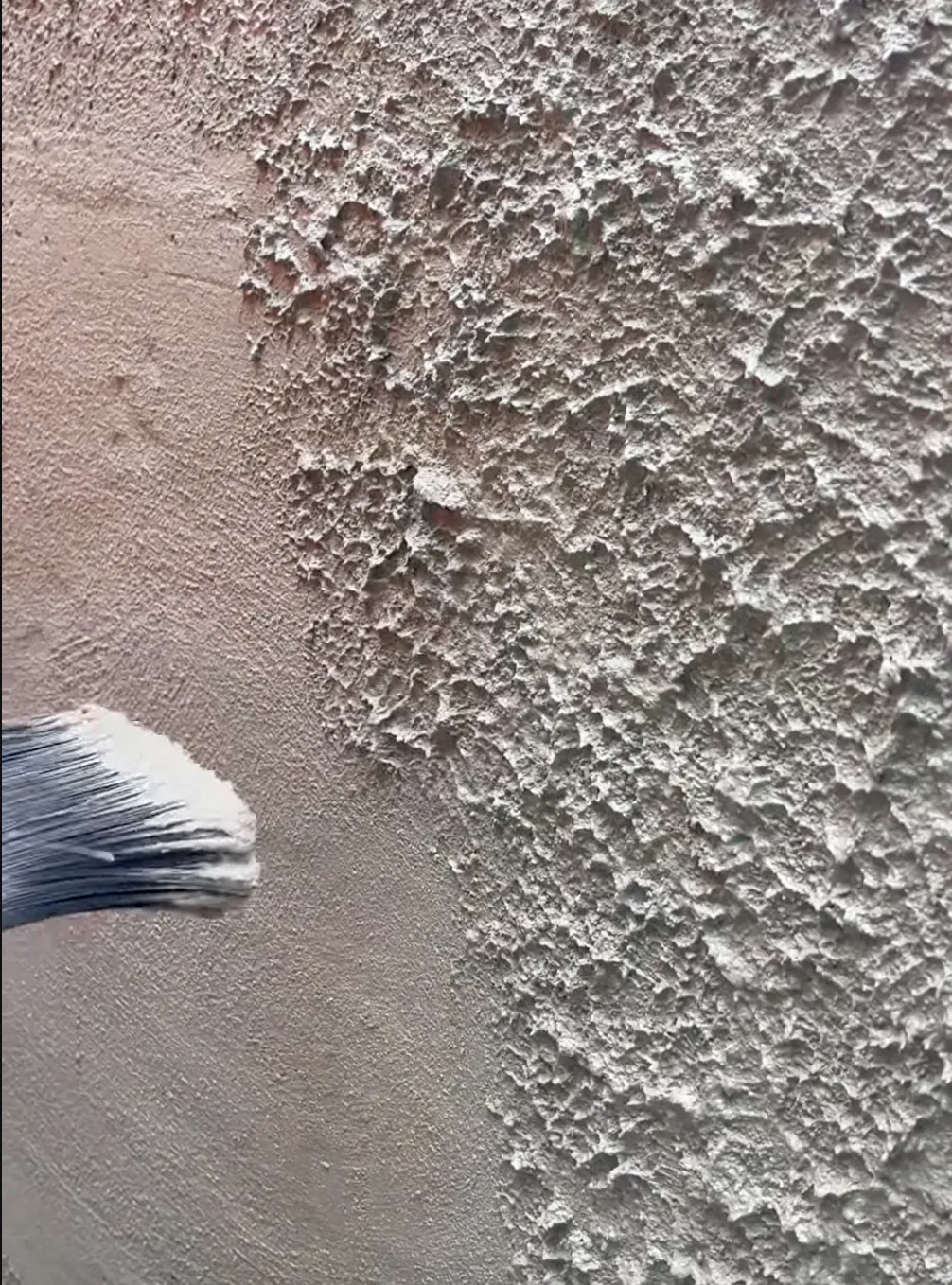 grey textured stucco & paint brush