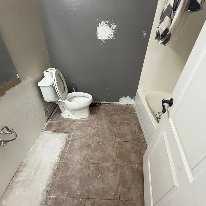 Phoenix bathroom after water damage demolition with vanity and lower drywall removed